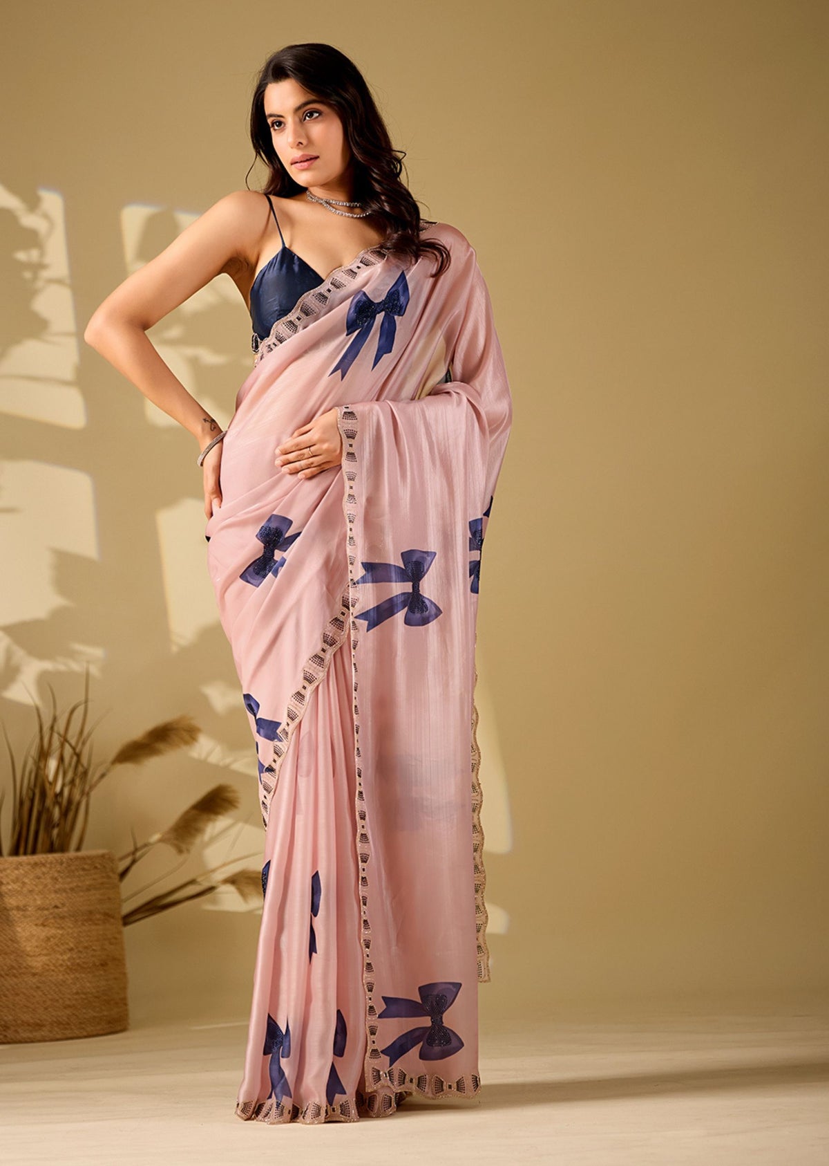 pink bow print saree pose with hand on hip