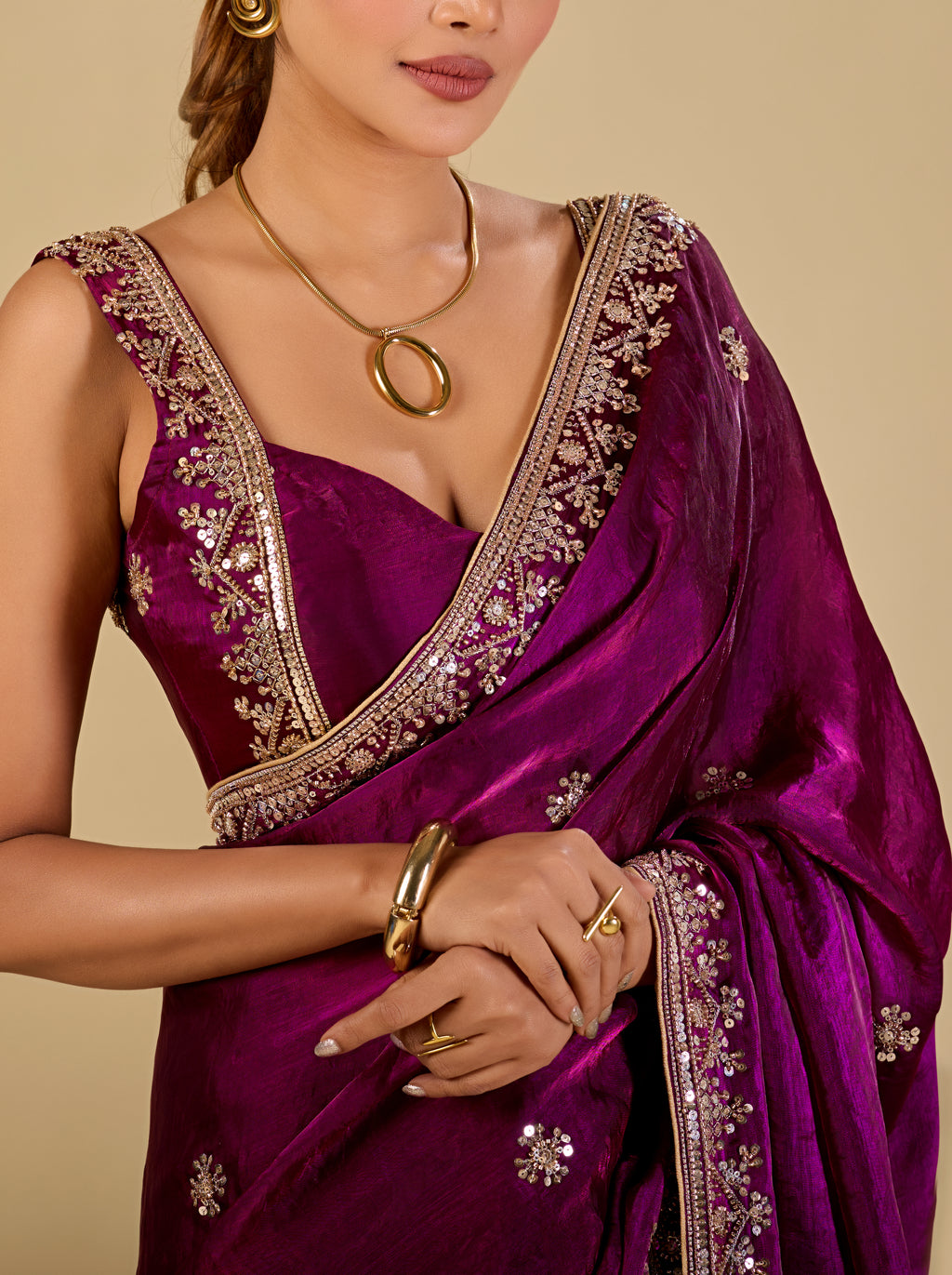 Woman wearing wine purple embroidered organza saree