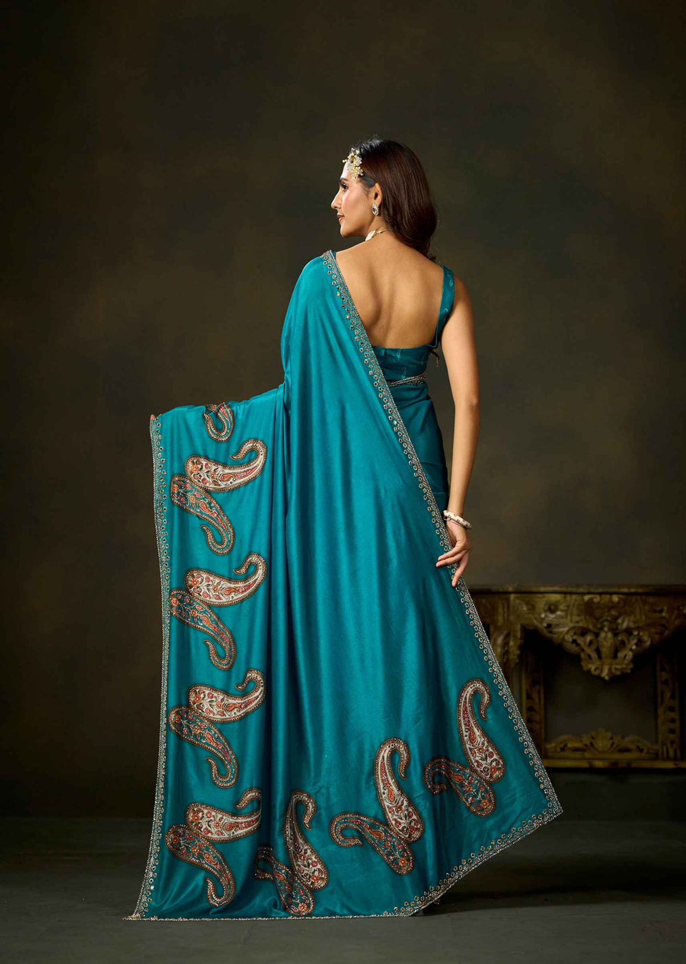 Back view of firozi satin silk saree featuring paisley embellished pallu and matching blouse by Ethnic9.