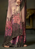 A close-up of a draped saree with a floral print in pink, magenta, and dark brown, paired with matching pleated fabric and a decorative border, shown on a model.