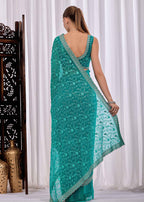 Firozi Chiffon Saree With Floral Embroidery And Stone Border