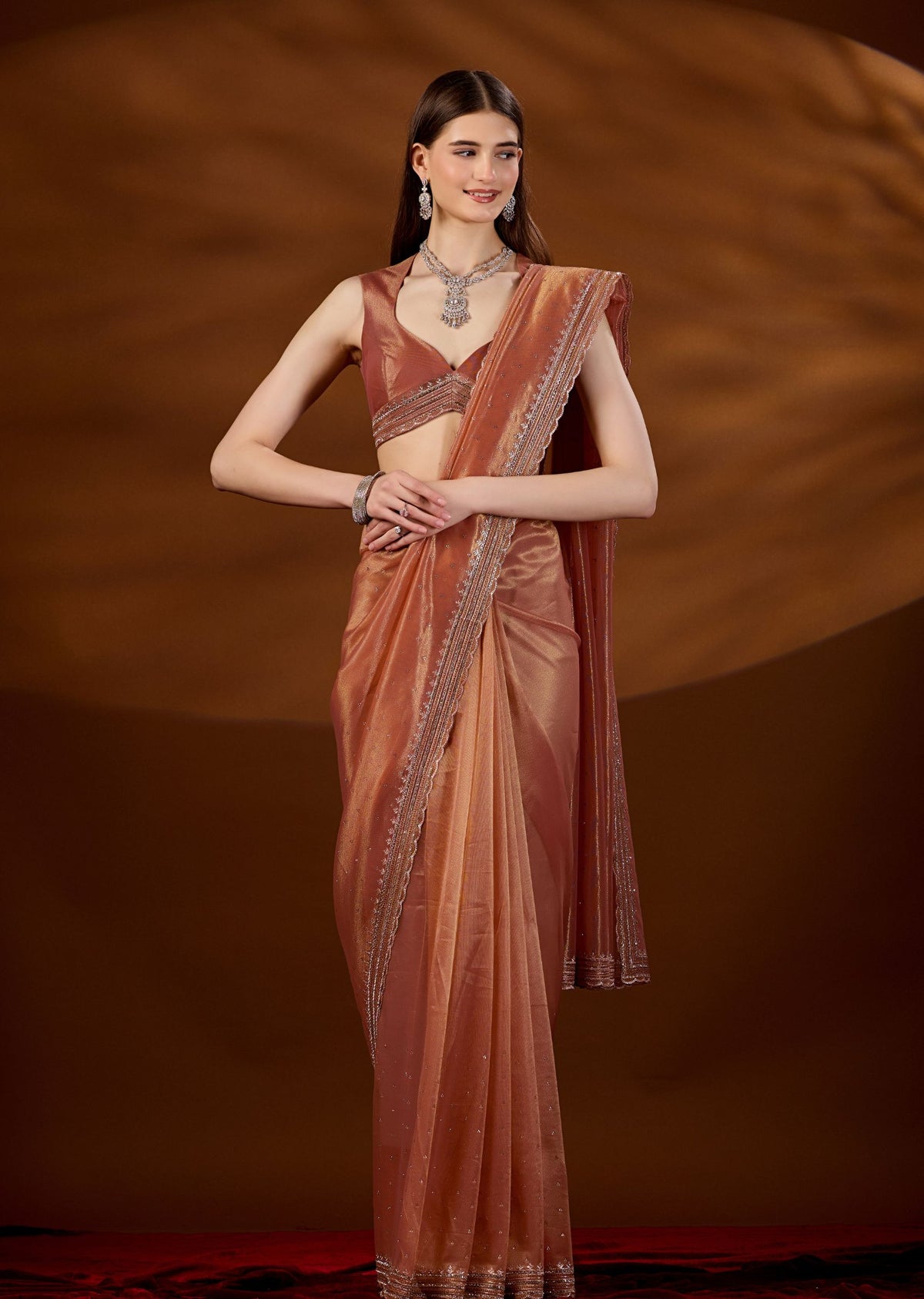 Peach Orange Tissue Saree Draped Pose - Festive Wear Saree