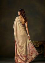 Back view of pink watercolor printed satin silk saree with flowing pallu and patterned border.