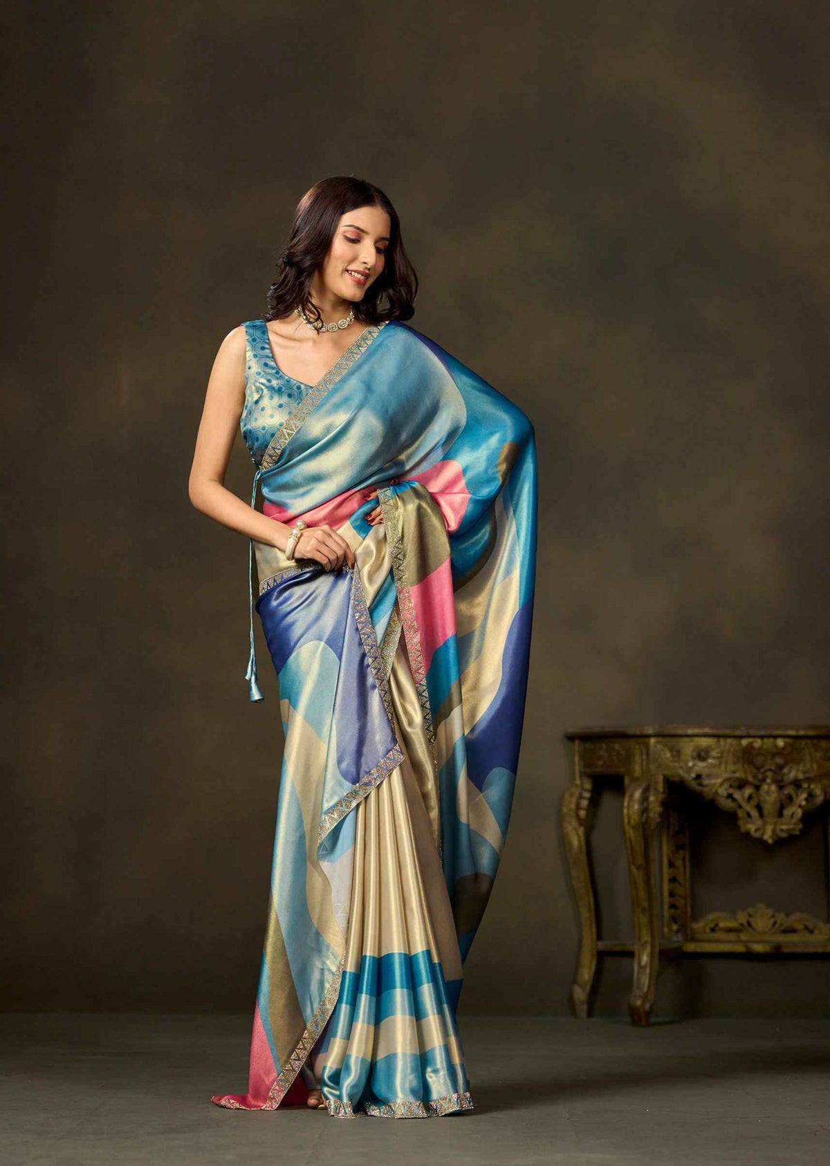 Elegant blue color block printed satin silk saree with multicolor pallu styled for festive occasions.