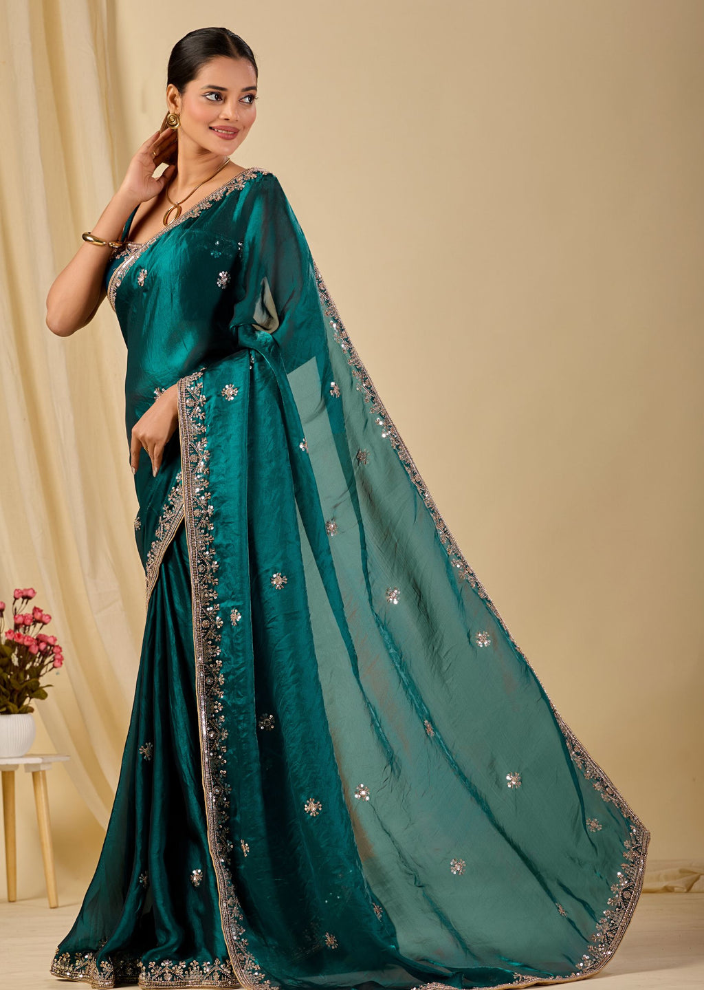 Teal green organza saree with floral sequin embroidery and embellished border
