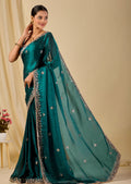 Teal green organza saree with floral sequin embroidery and embellished border