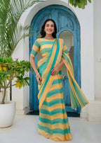 A woman wearing a yellow and teal striped saree